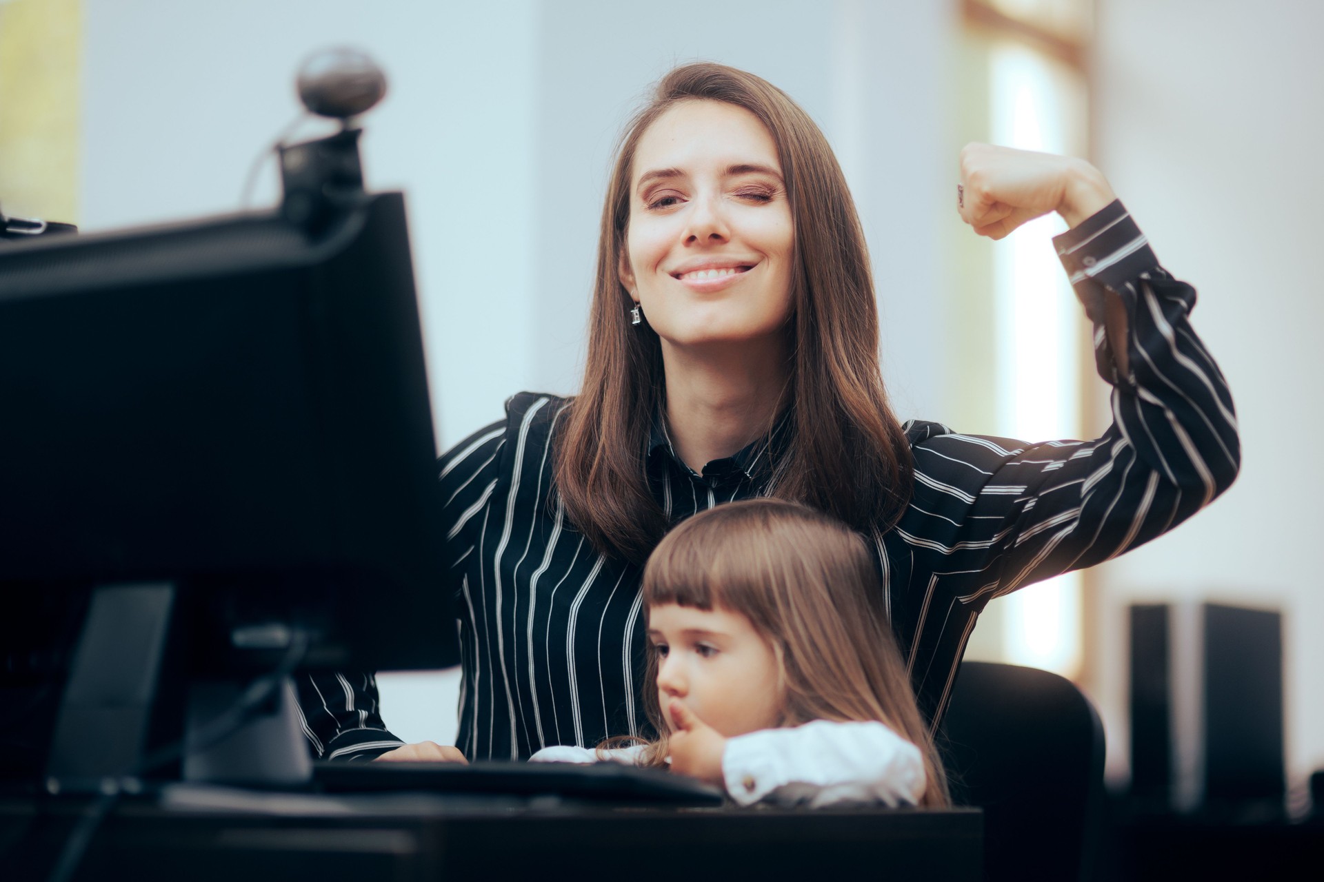 Strong Mom Flexing Her Muscles while Multitasking at Work